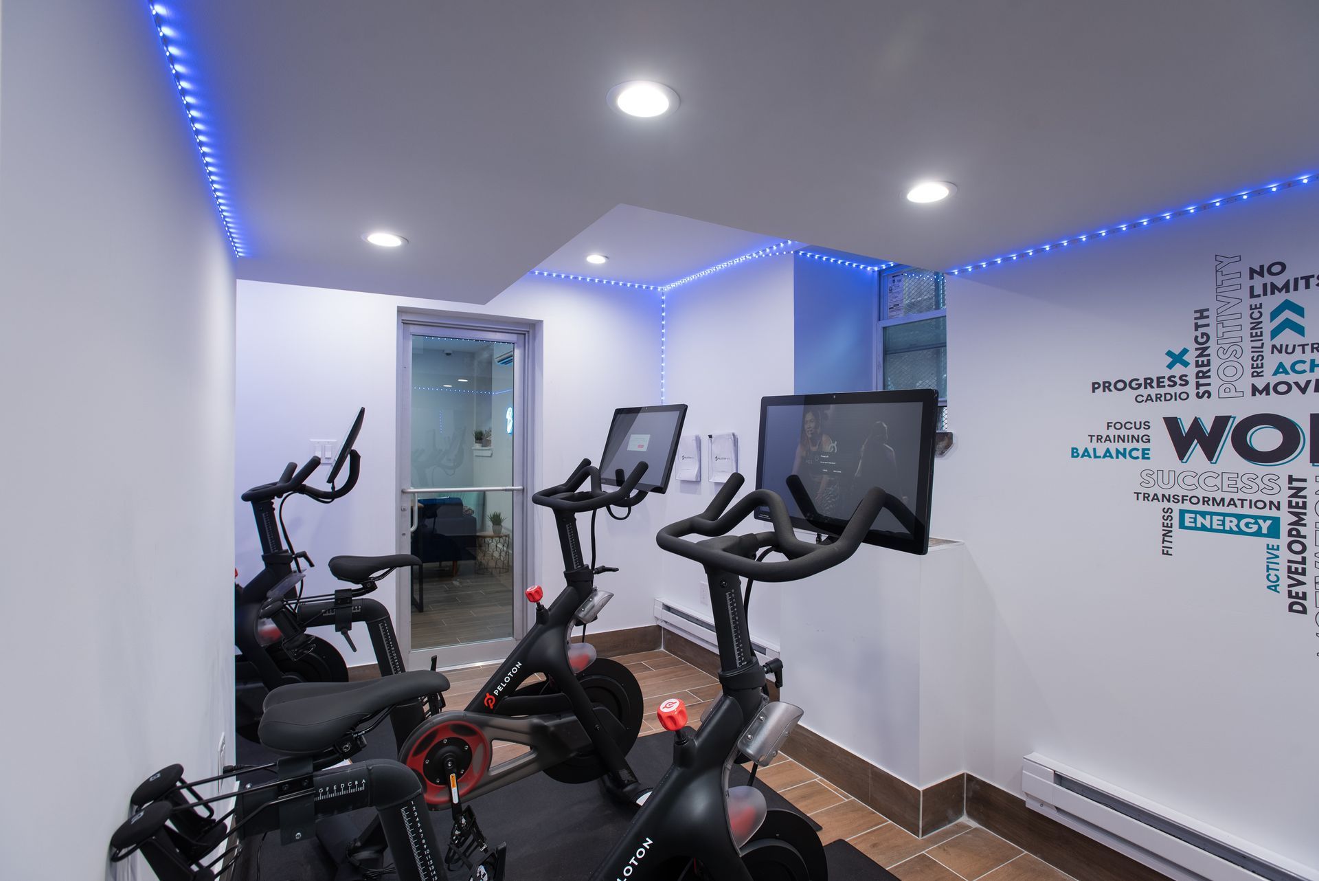 There are a lot of exercise bikes in this room.
