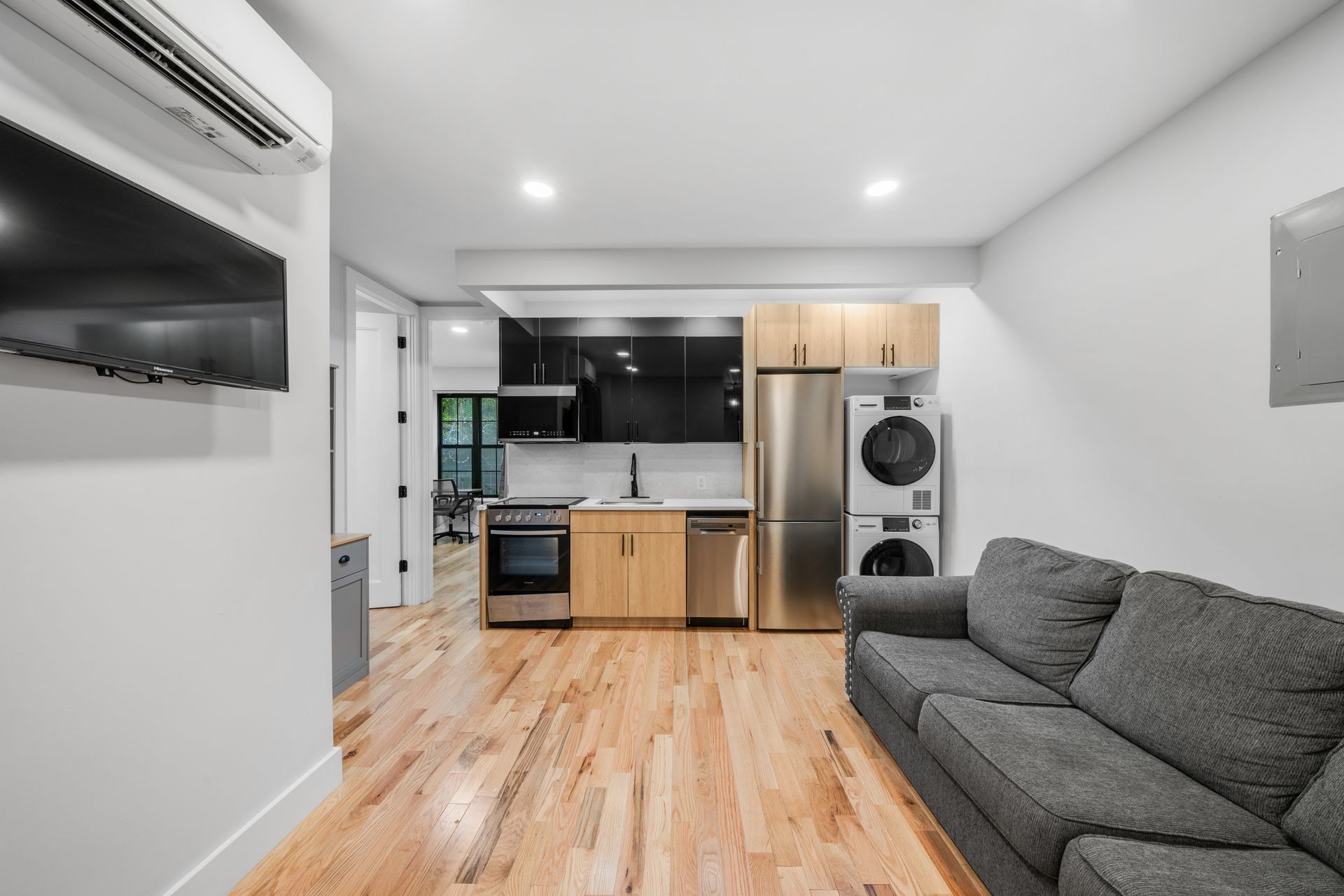 A living room with a couch and a kitchen in the background