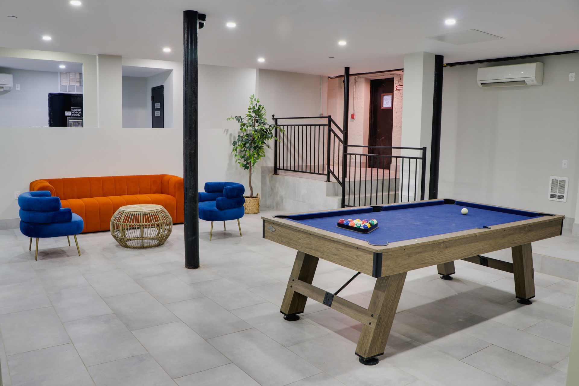 There is a pool table in the middle of the room.