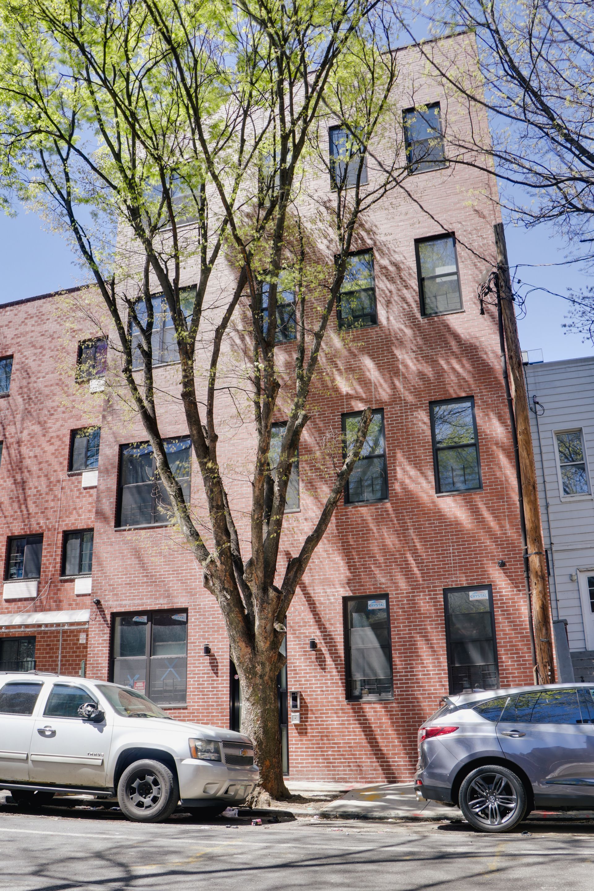 A brick building with cars parked in front of it.