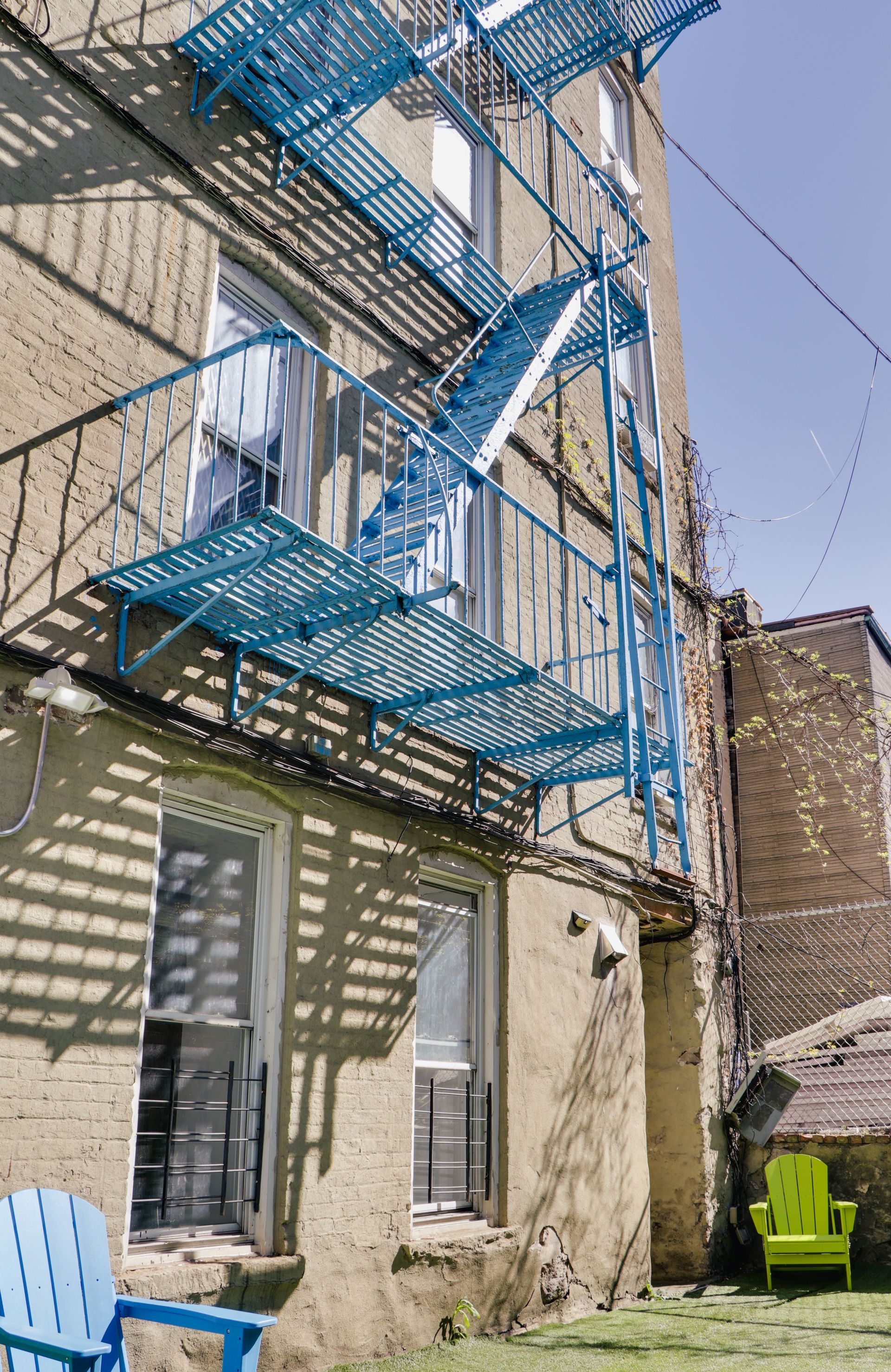 A blue fire escape on the side of a building