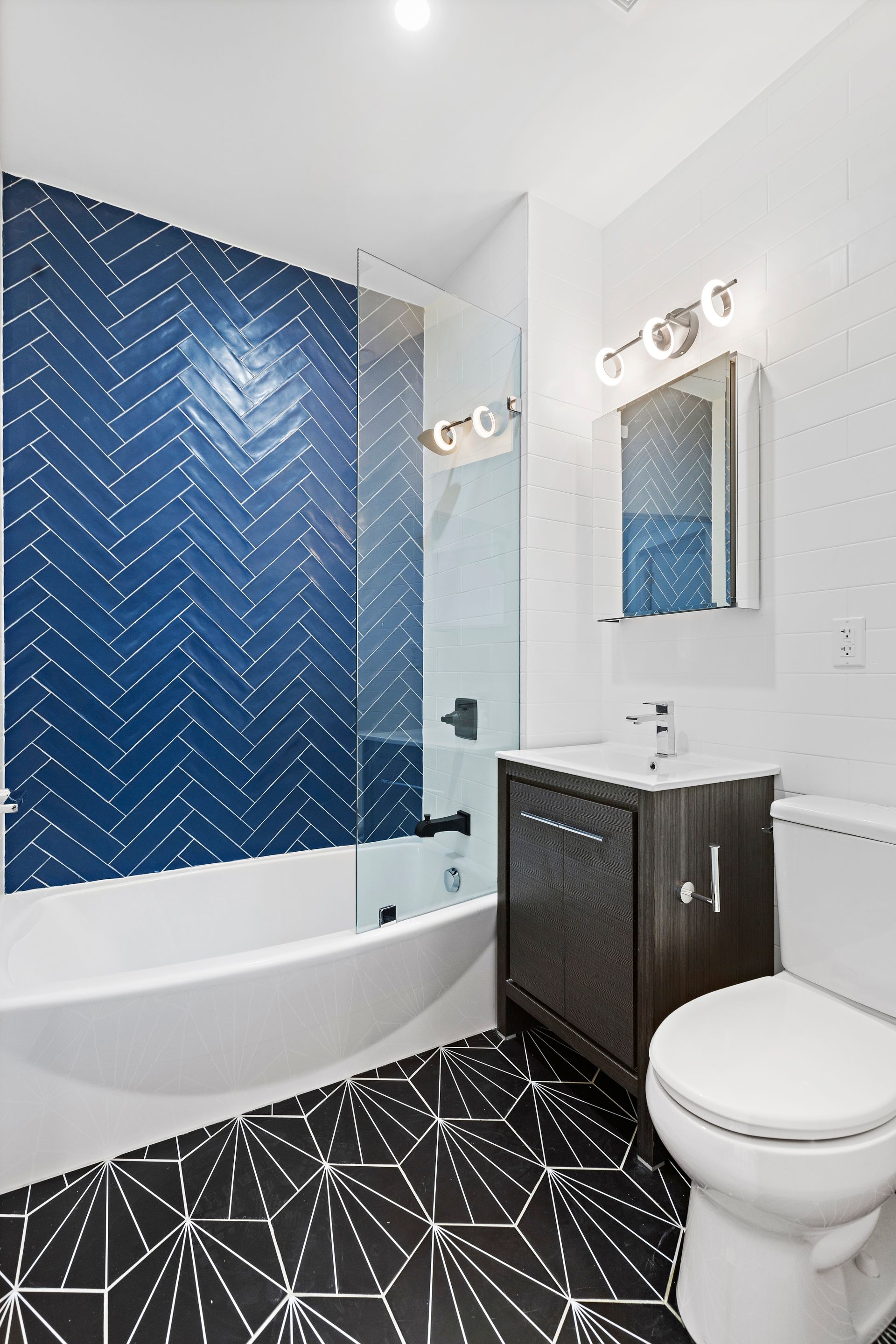 A bathroom with a toilet , sink , and bathtub