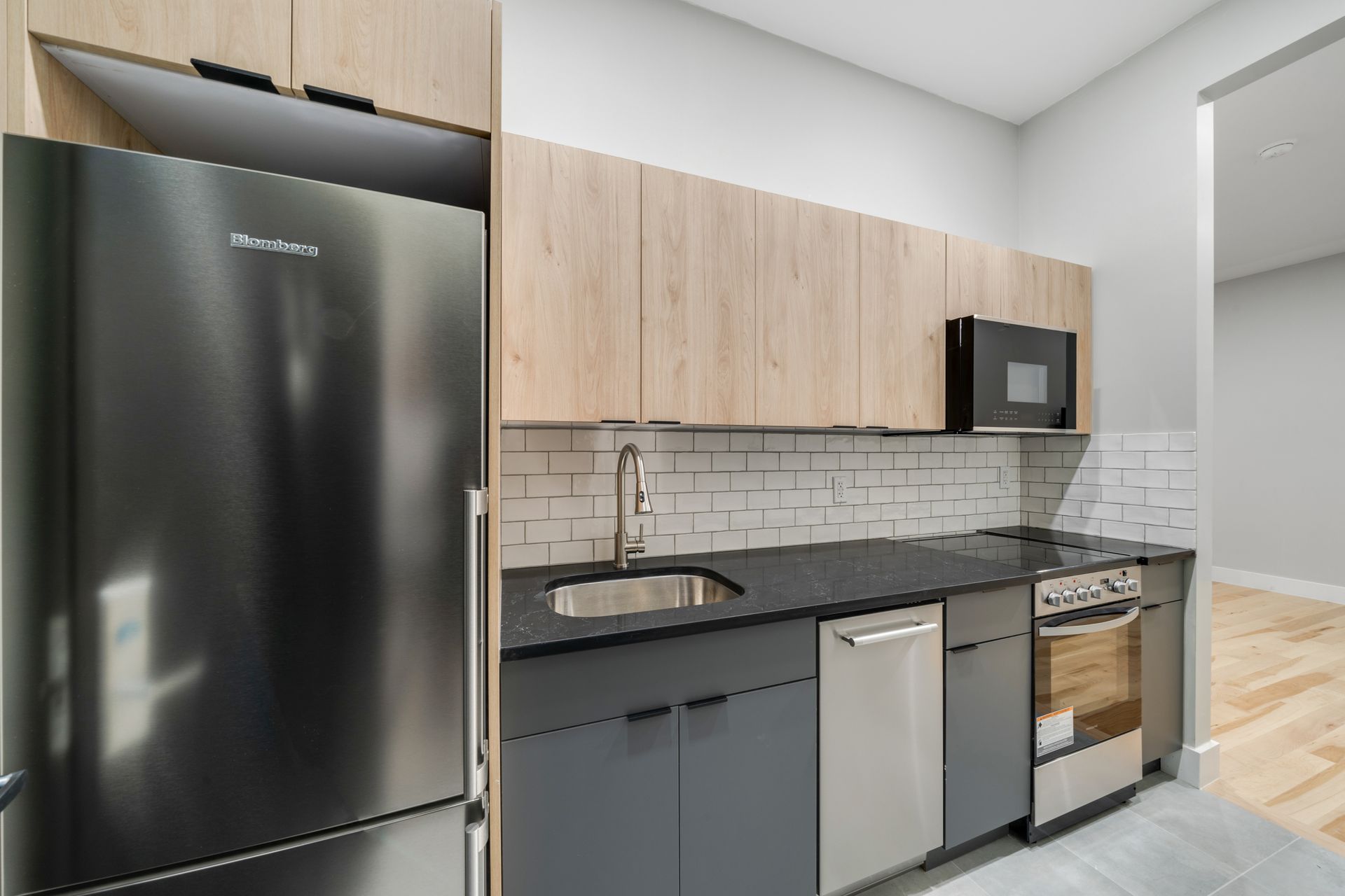 A kitchen with stainless steel appliances and wooden cabinets