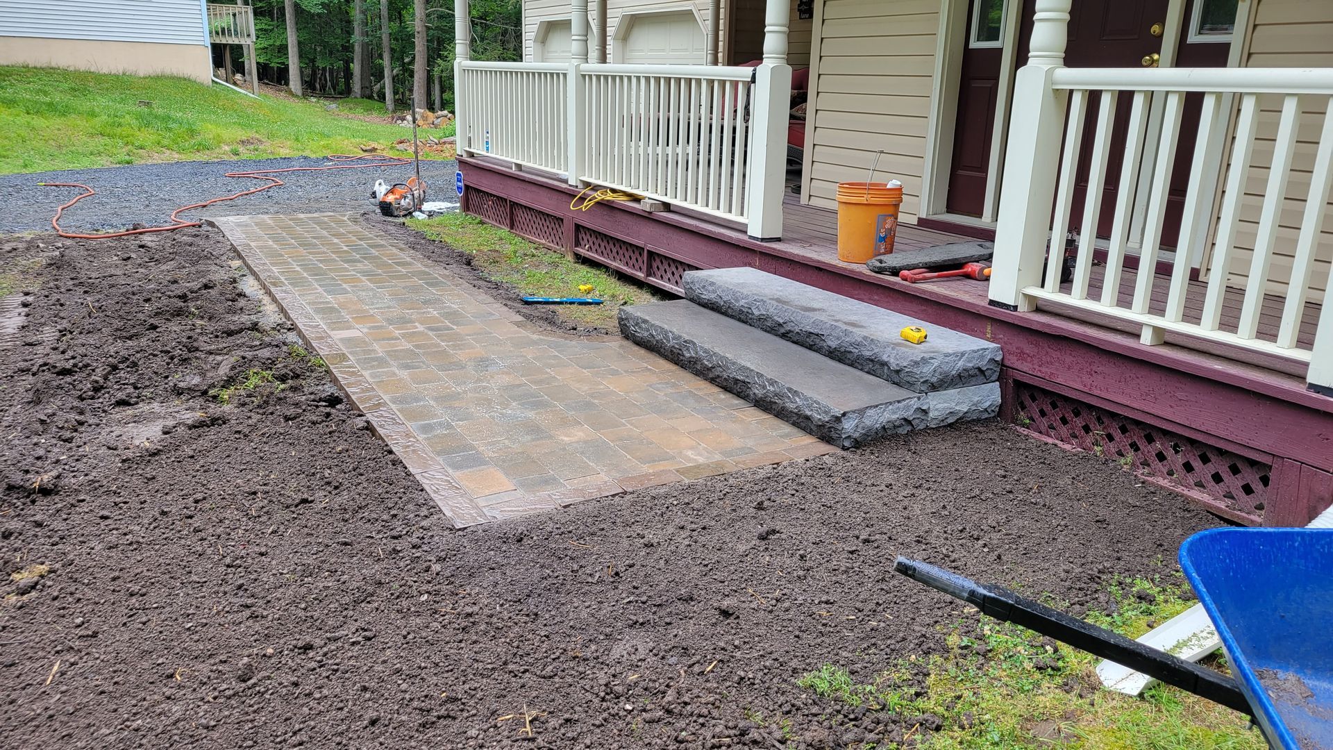 a house with a porch and steps is being remodeled .