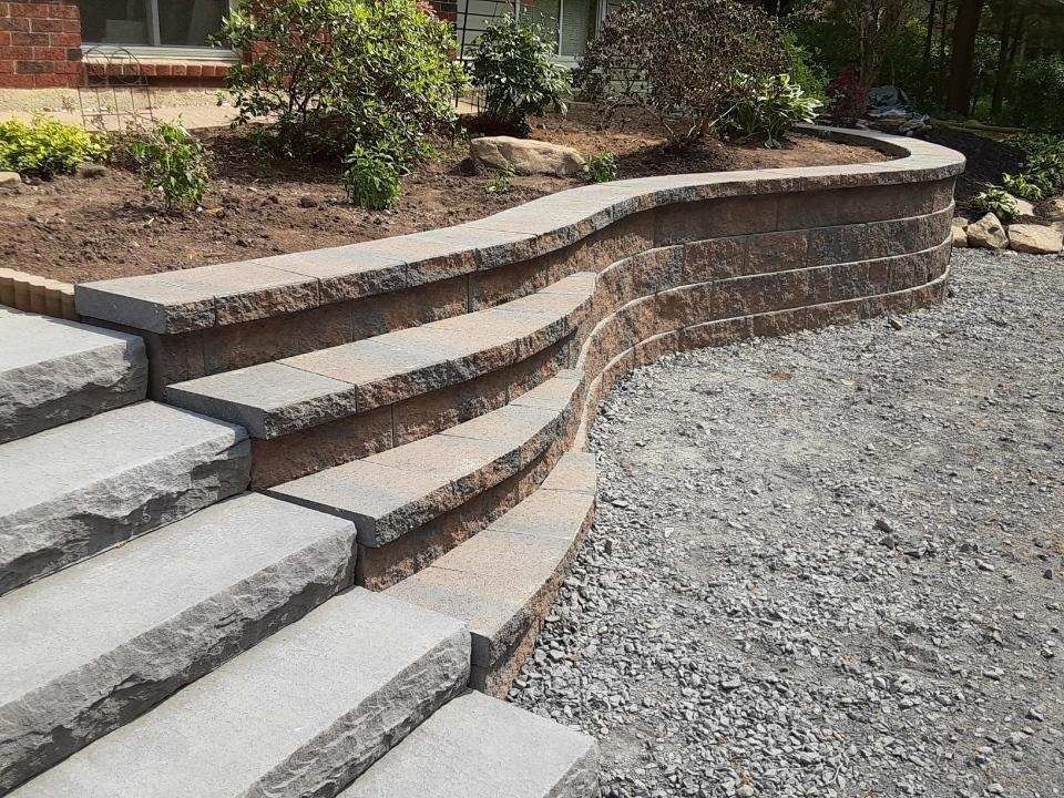 A set of stairs leading up to a stone wall