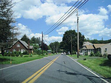 A road with a lot of houses on the side of it A road with a lot of houses on the side of it