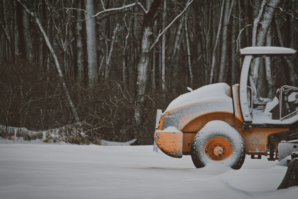 A garden tractor covered in frost and snow. A garden tractor covered in frost and snow.