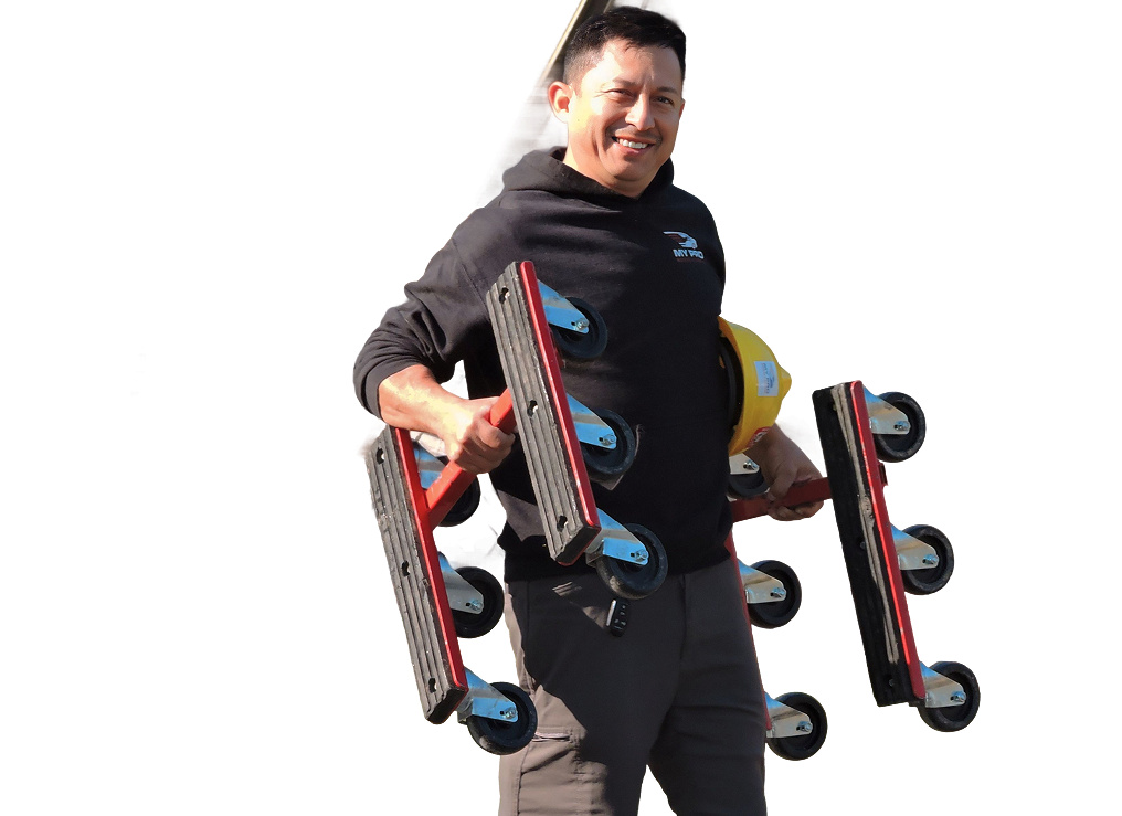 Man holding three black-and-red inline moving dollies, smiling against a white background