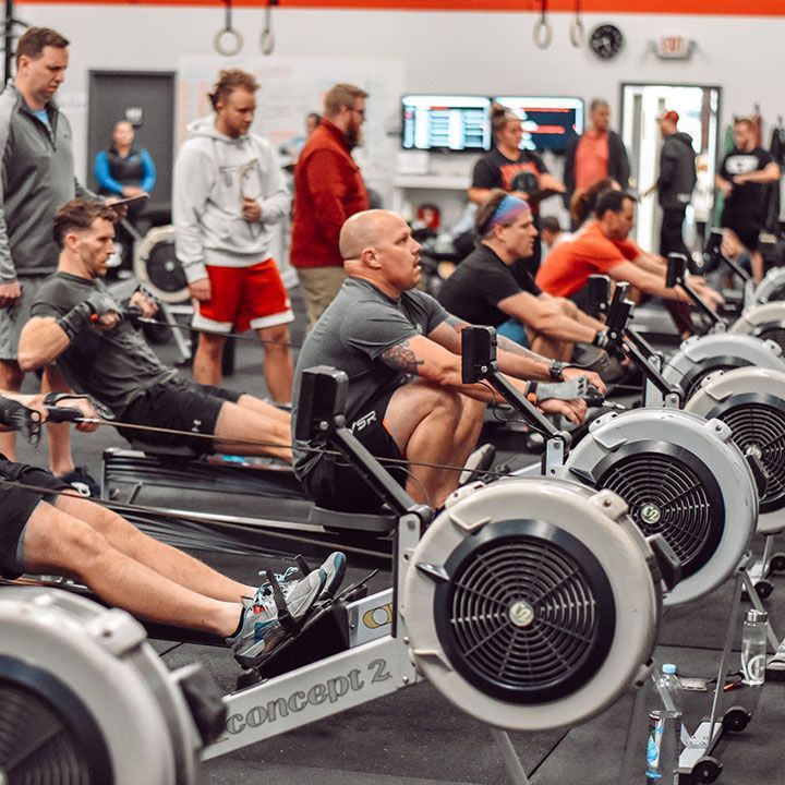 A group of people are using rowing machines at CrossFit Garage gym in Woodstock, GA