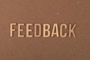 The word “FEEDBACK” in raised beige letters on a brown background.