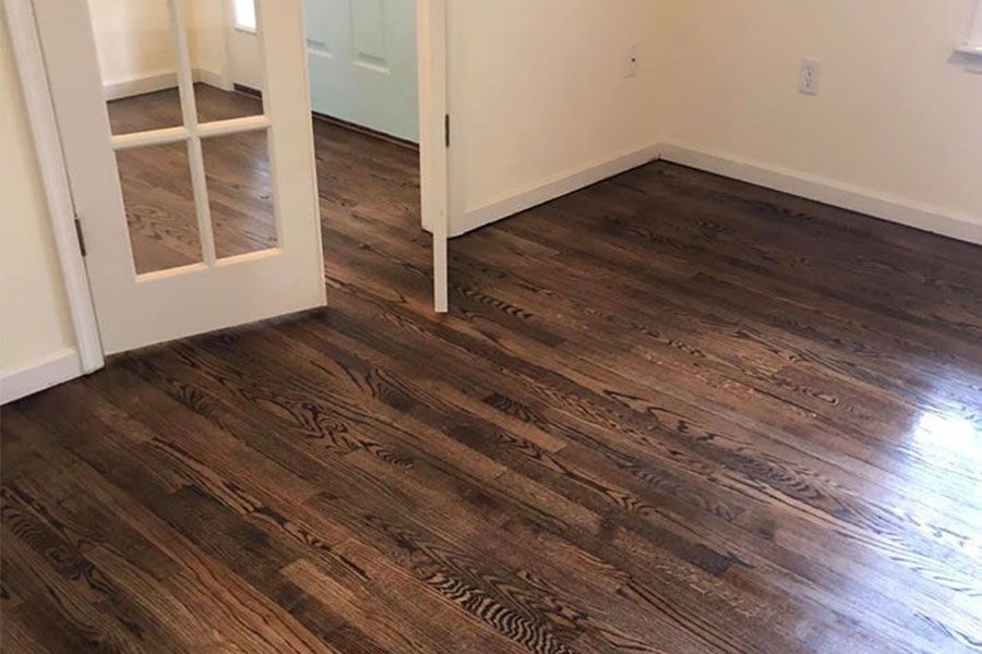 A room with hardwood floors and a french door.
