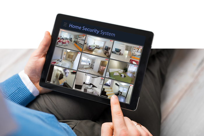 Man Using Tablet for Home Security System