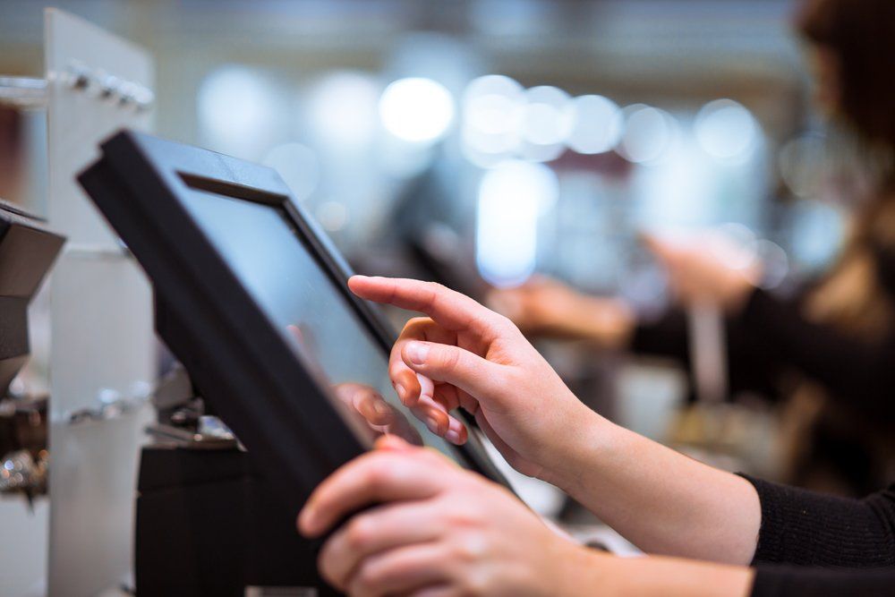 Cashier Using a POS System for Billing