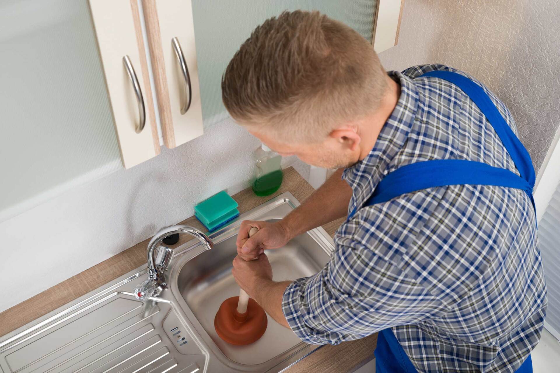 Pressing Plunger In Steel Kitchen Sink – Melbourne, VIC – Catco Plumbing