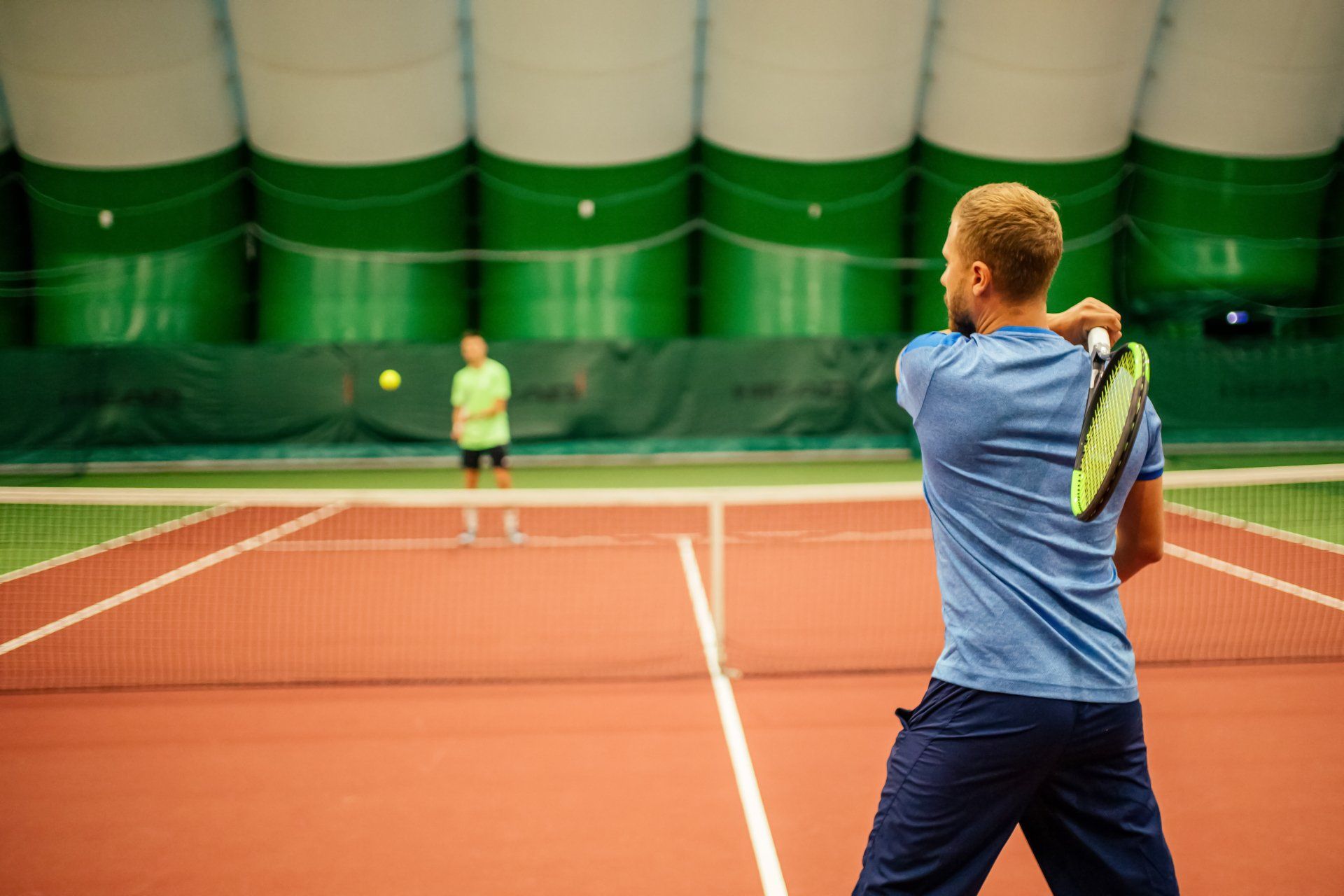 Two men playing tennis indoors