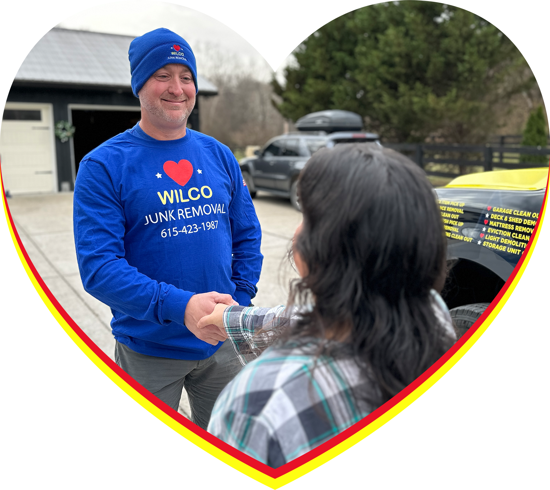 A man in a blue shirt is shaking hands with a woman.