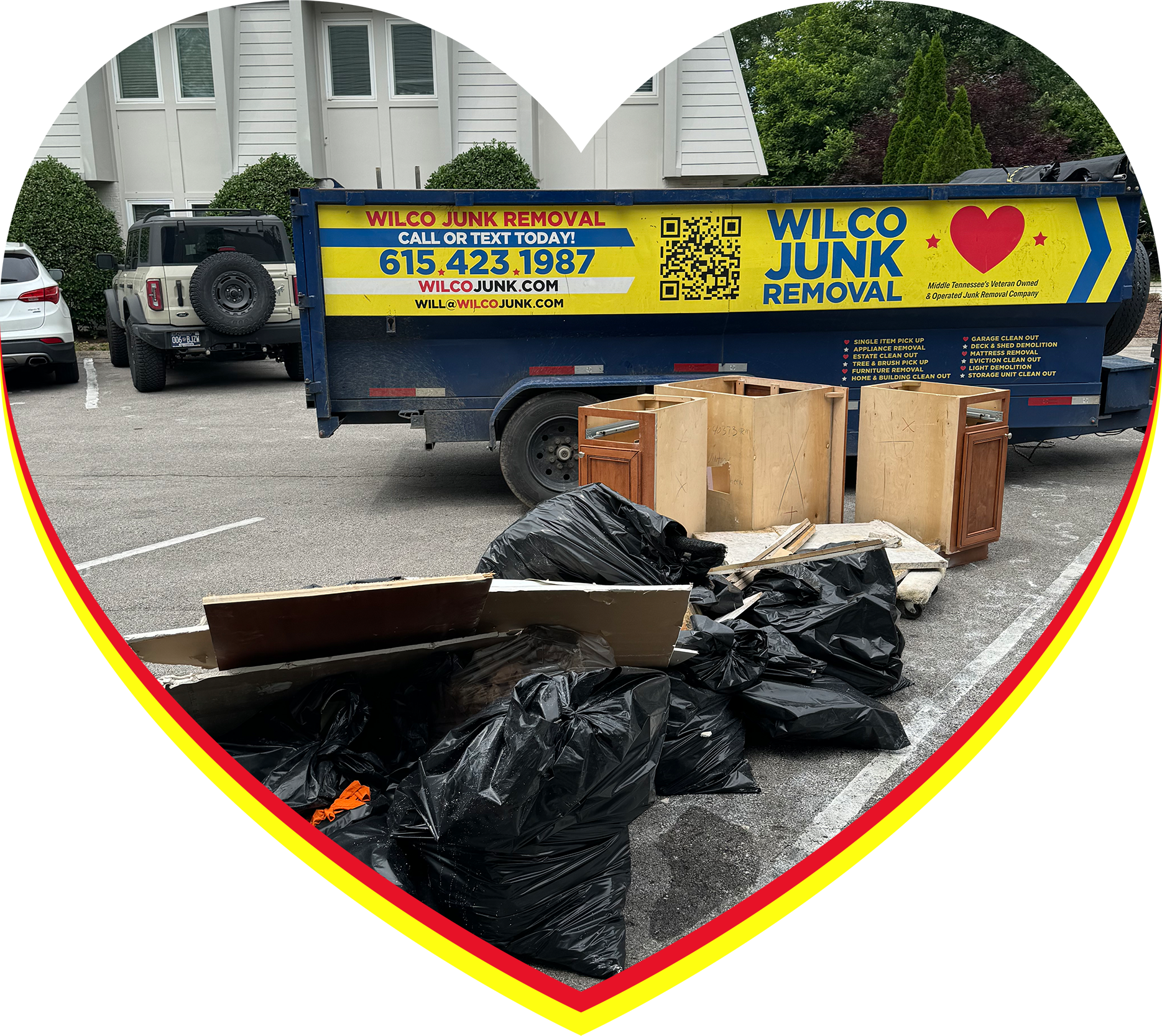  A pile of trash bags and cabinets ready for junk removal