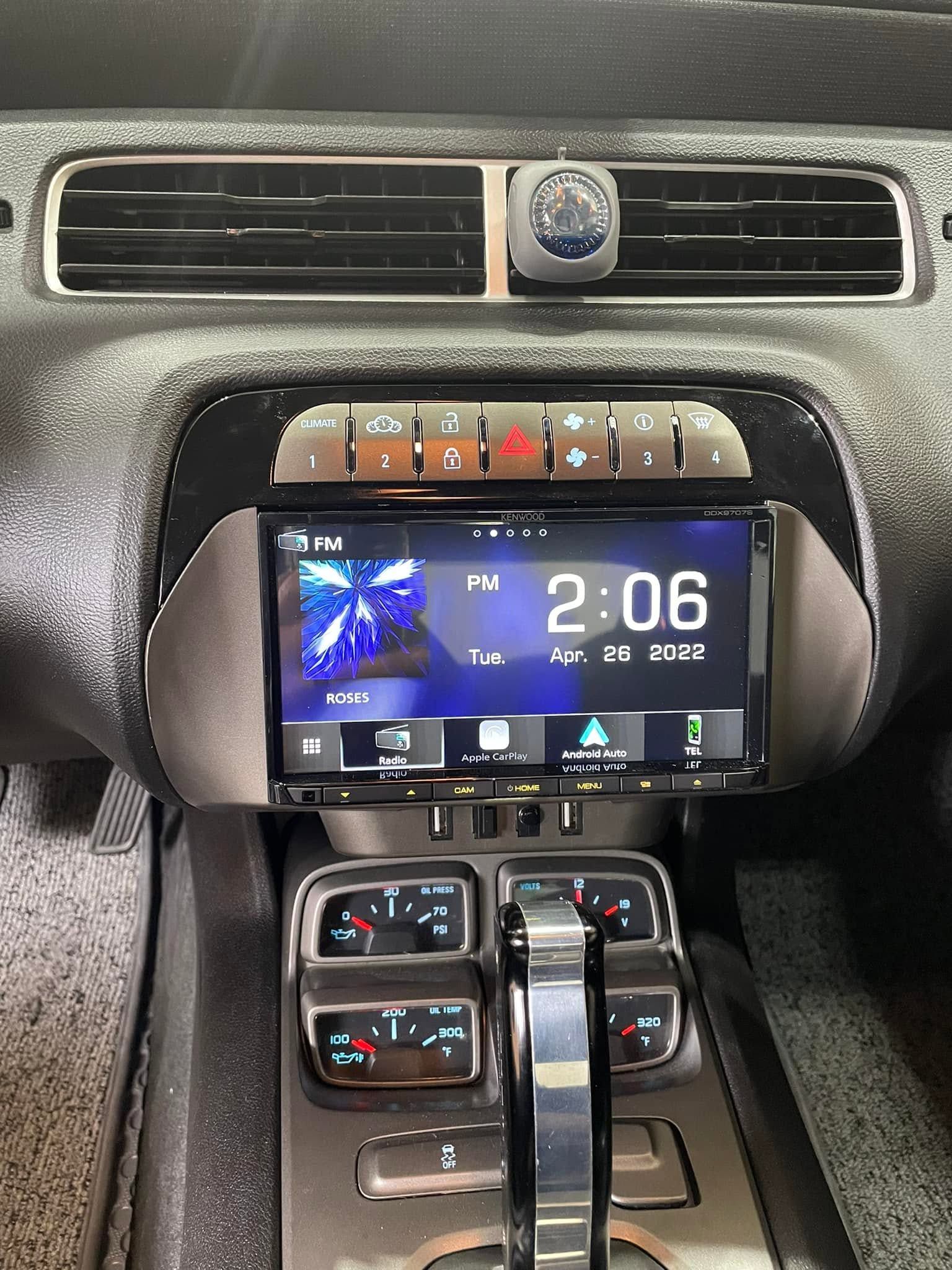 Car dashboard with a digital infotainment screen showing 2:06 and climate controls below.