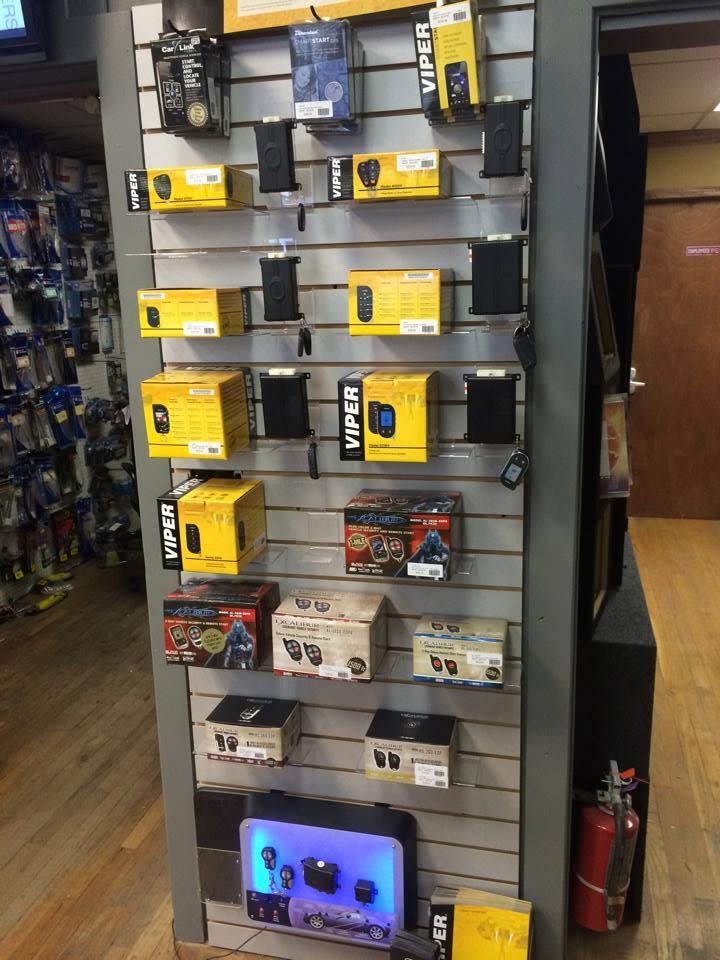 Display of electronics accessories on wall shelves, with yellow, black, and white product boxes.