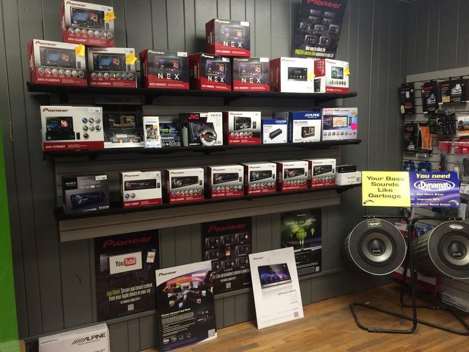 Electronics display wall with boxed audio and computer gear on shelves in a store.