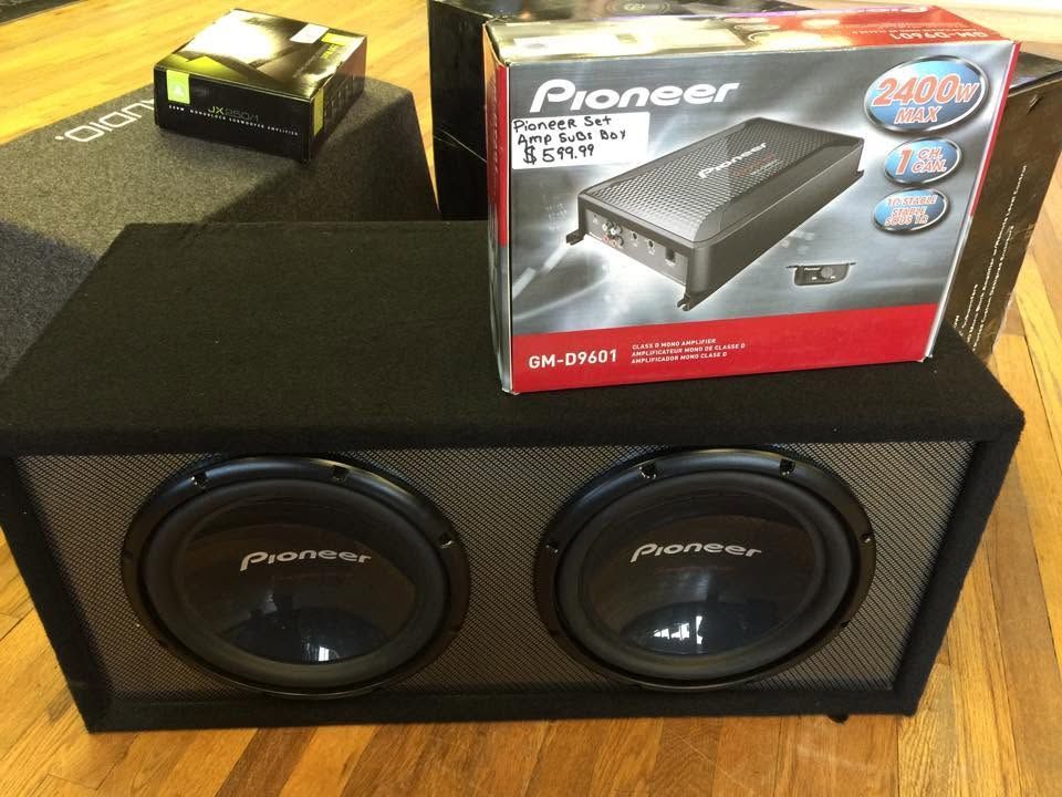 Pioneer dual subwoofer car audio box with a Pioneer amp package on top, on a table.