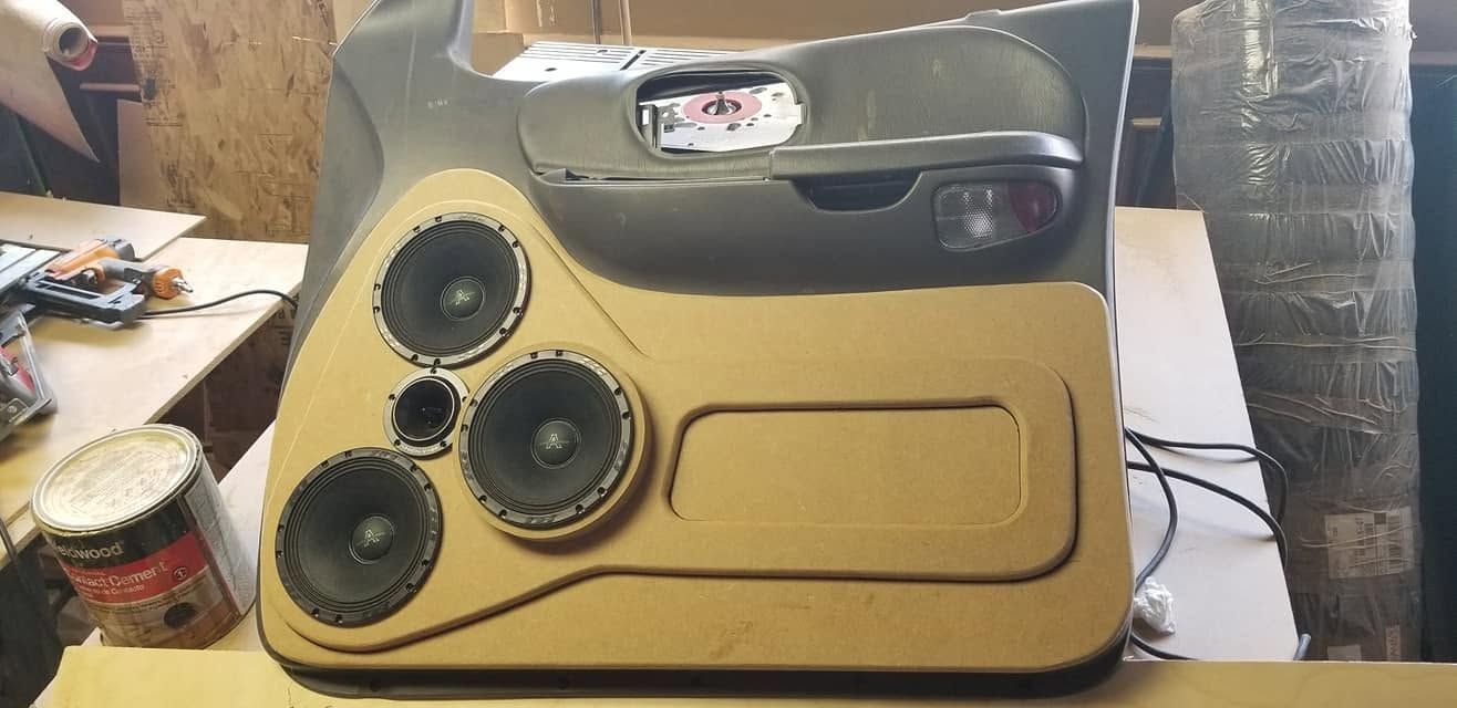 Vintage olive-and-cream appliance front with three black circular dials and a small top display.