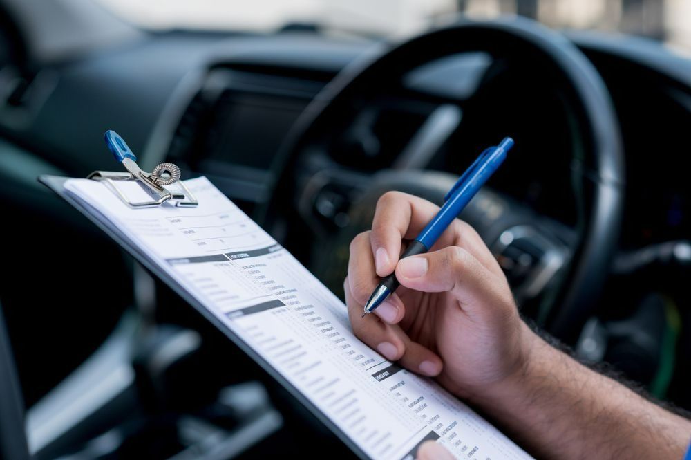 Person Inside a Car, Holding a Clipboard and Pen — Barnco Automotive Repairs in Taminda, NSW