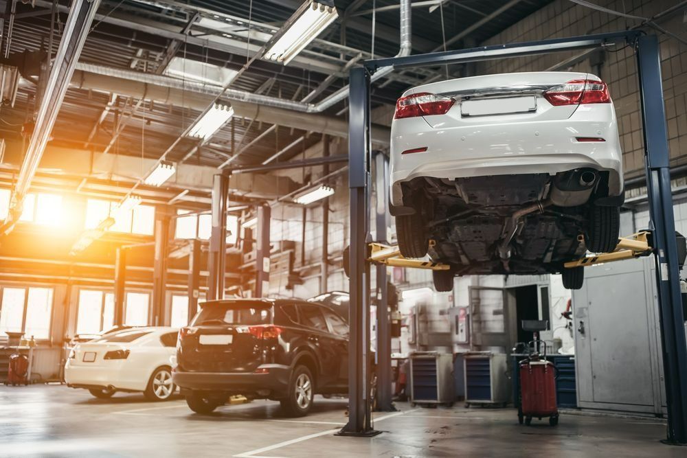 Car Repair Shop With a Vehicle Lifted on a Hydraulic Hoist — Barnco Automotive Repairs in Tamworth, NSW
