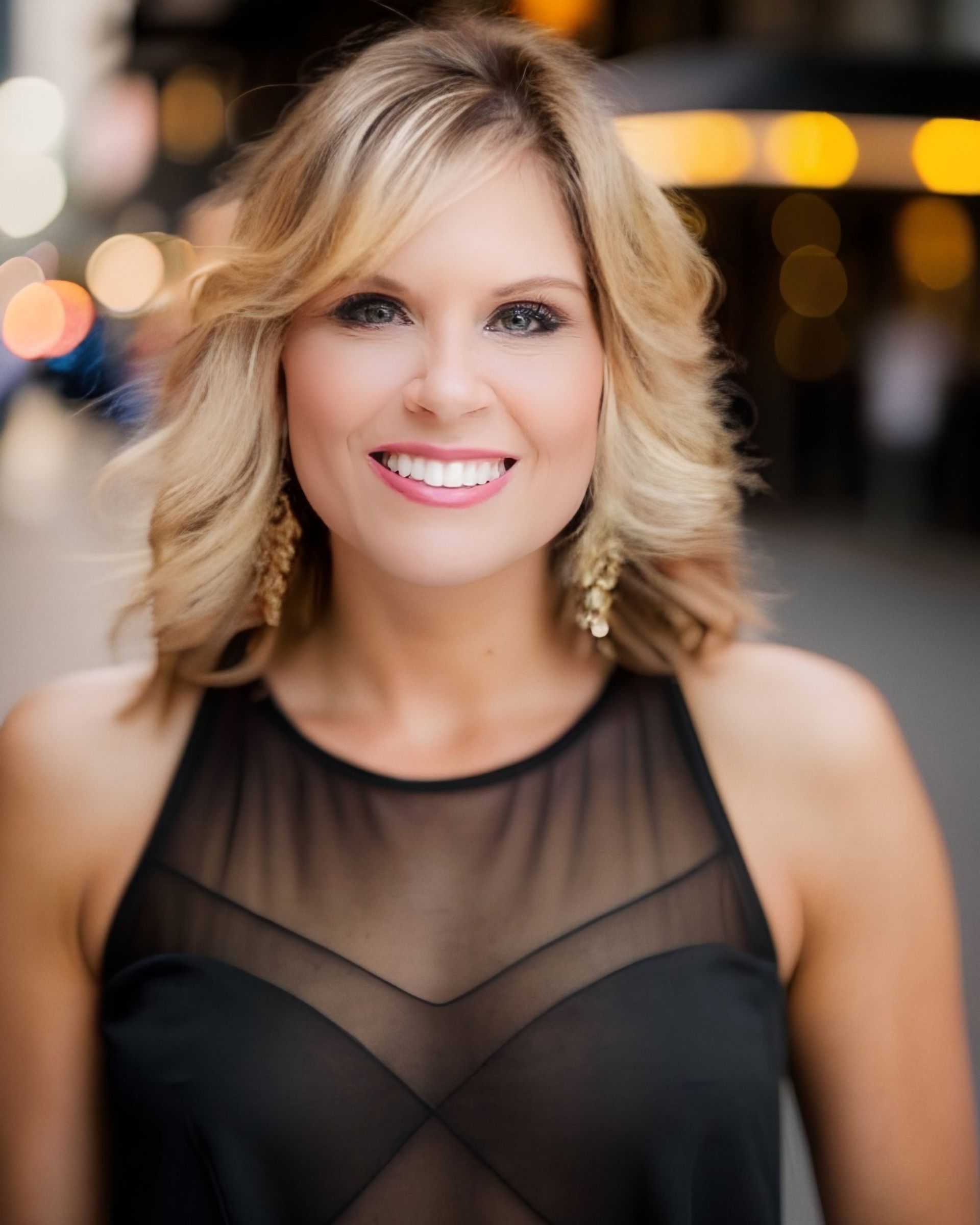 Lady Jen Du Plessis in a black dress is smiling for the camera