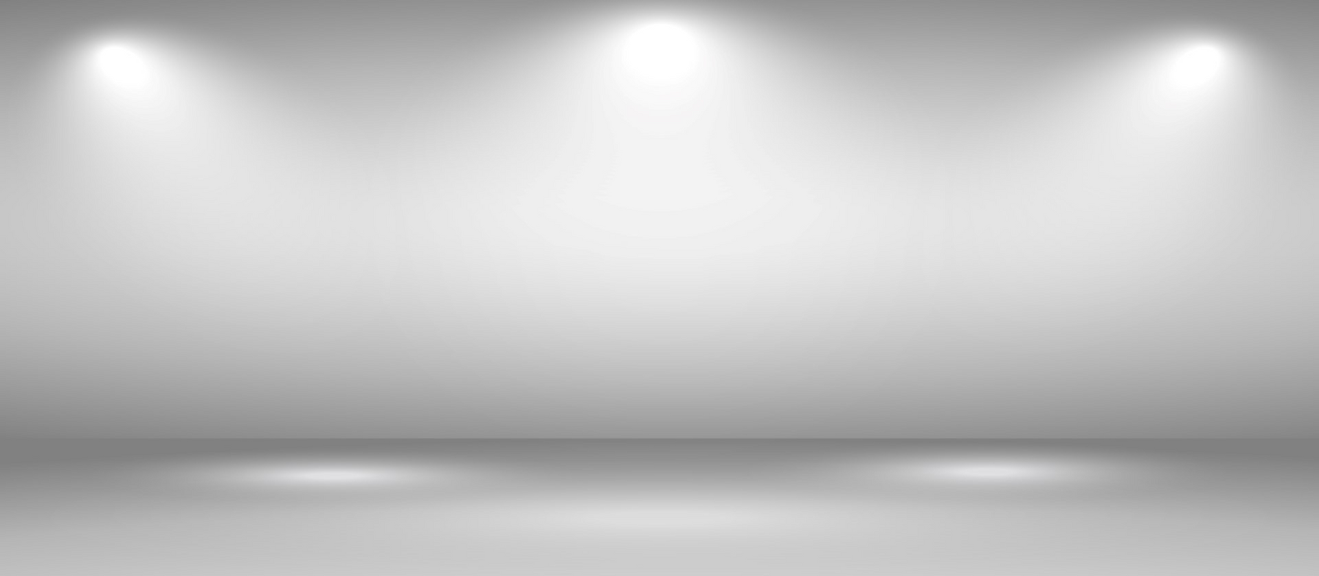 A white room with spotlights on the wall and floor.