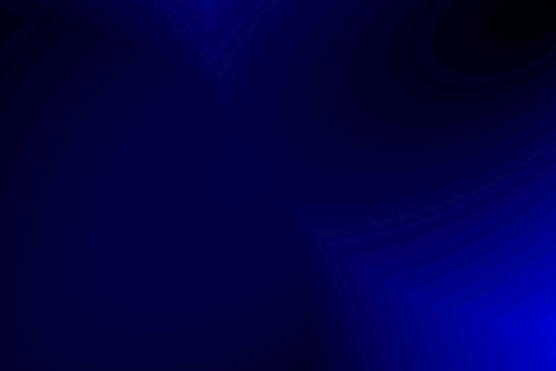 A dark blue background with a few spots of light on it