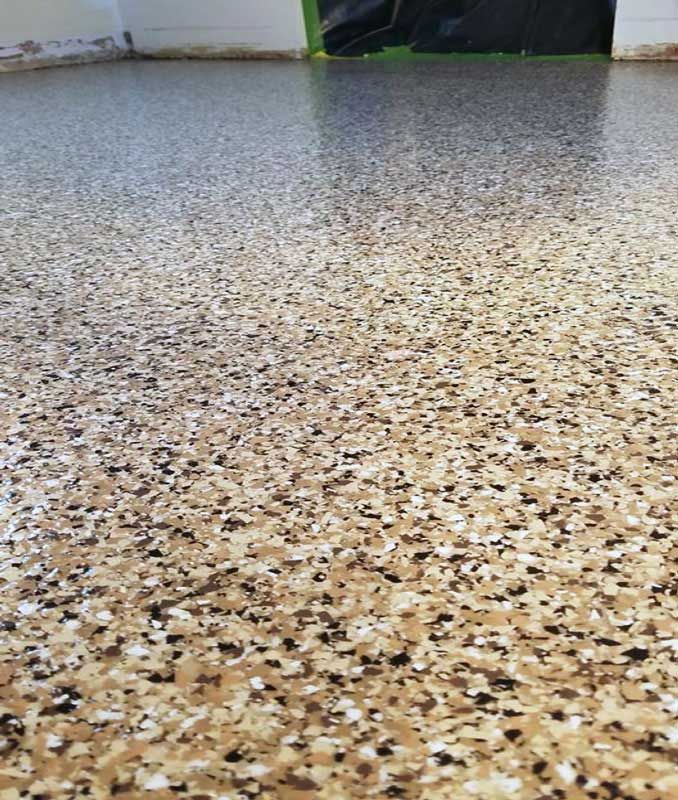Speckled beige terrazzo floor with a gray floor section in the background