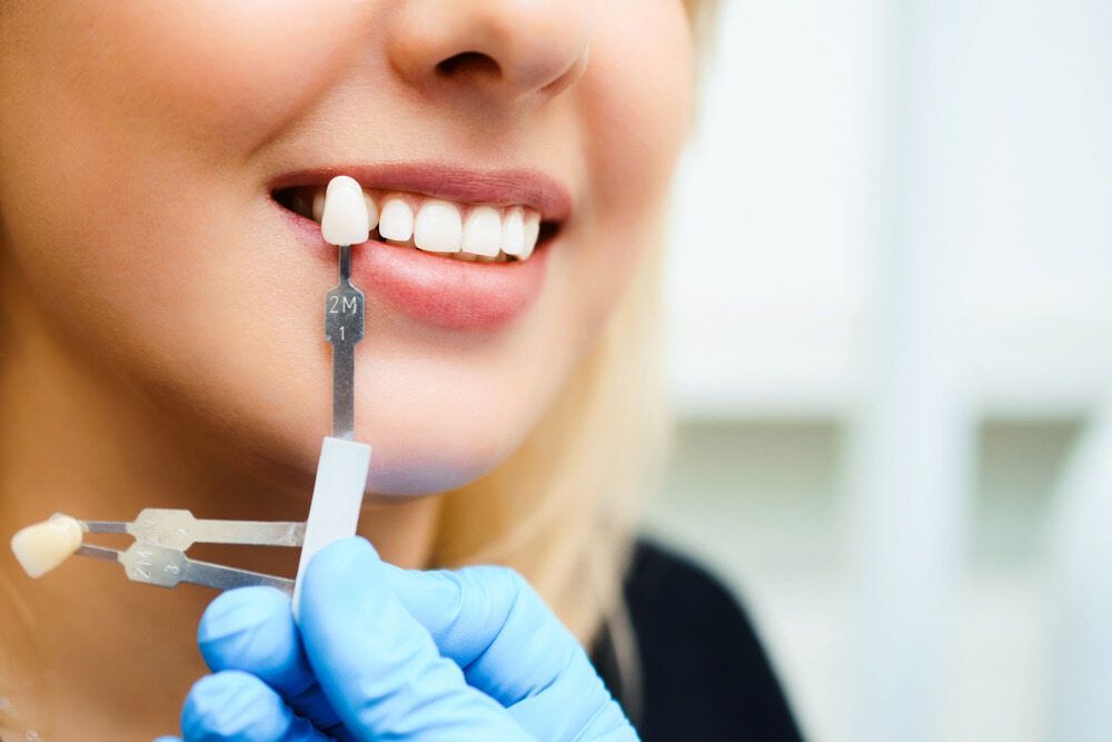 A Dentist Is Working On A Model Of A Tooth — Dental Care Smithfield In Smithfield, QLD
