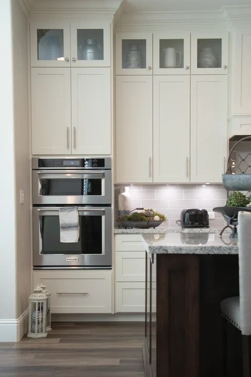 A Kitchen With White Cabinets and Stainless Steel Appliances — Bruce Smith Cabinets in Bray Park, NSW