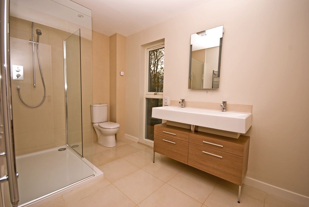 A Bathroom With a Toilet, Sink, Mirror and Walk in Shower — Bruce Smith Cabinets in Bray Park, NSW