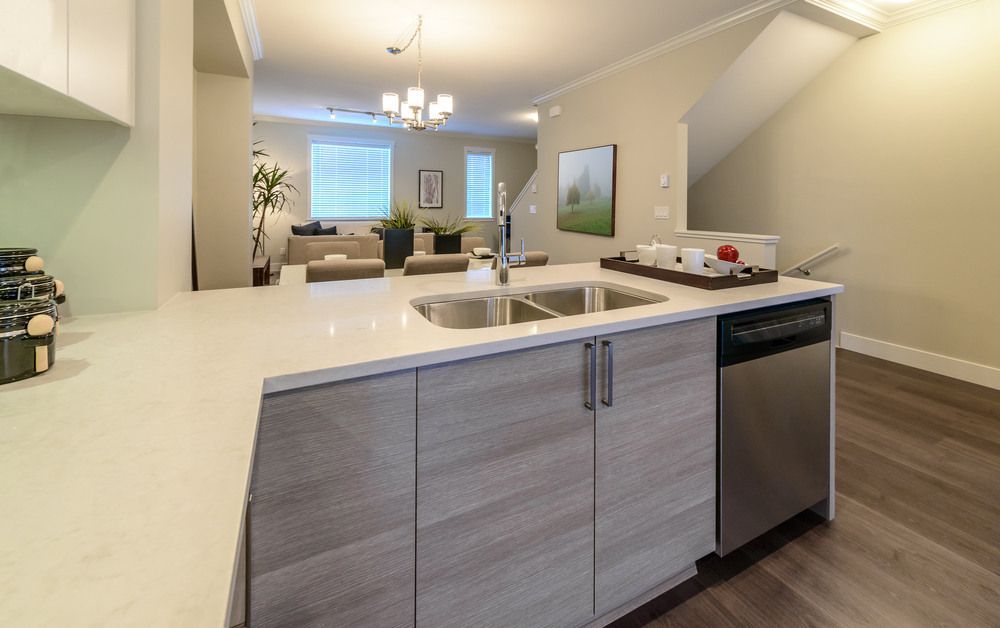 A Kitchen With a Sink and a Dishwasher in a House — Bruce Smith Cabinets in Mullumbimby, NSW