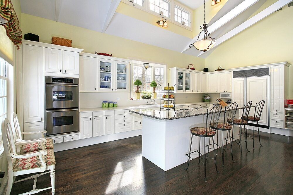 A Kitchen With White Cabinets and Stainless Steel Appliances — Bruce Smith Cabinets in Bray Park, NSW