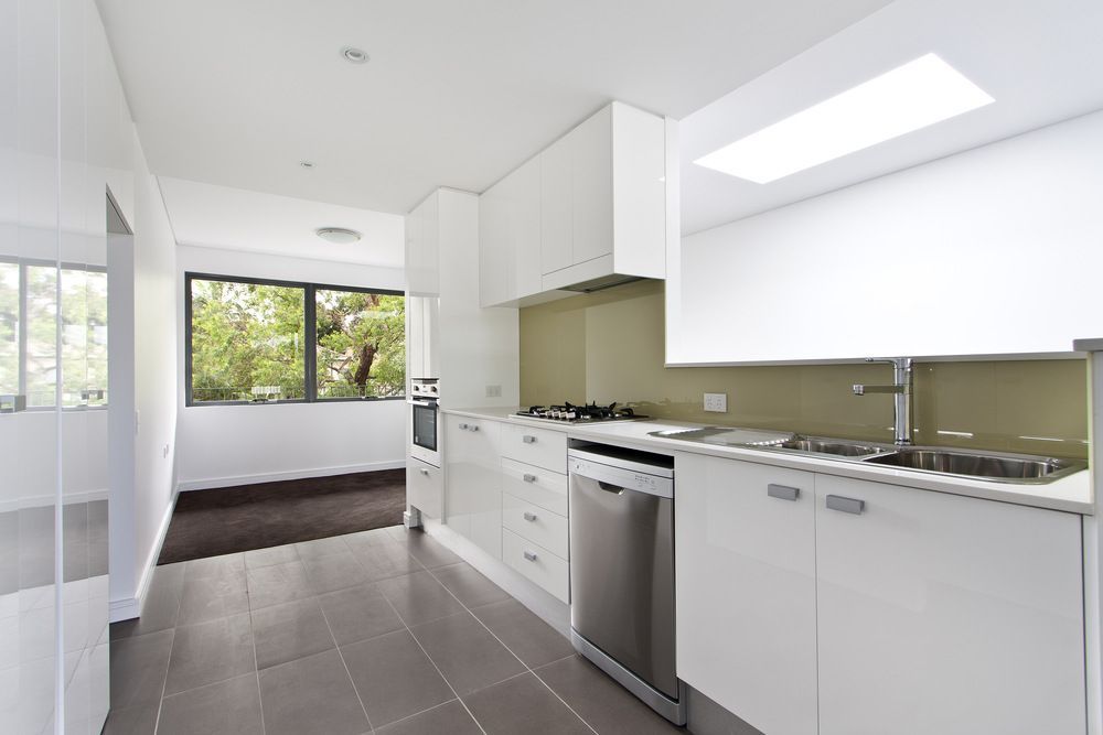 A Kitchen With White Cabinets and Stainless Steel Appliances  — Bruce Smith Cabinets in Bray Park, NSW