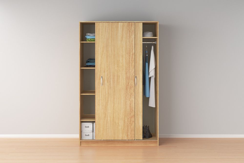 A Wooden Wardrobe With Sliding Doors and Shelves in a Room — Bruce Smith Cabinets in Mullumbimby, NSW