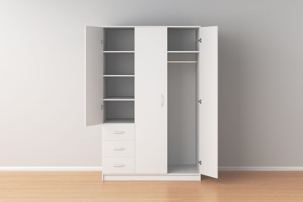 A White Wardrobe With the Doors Open in an Empty Room — Bruce Smith Cabinets in Mullumbimby, NSW