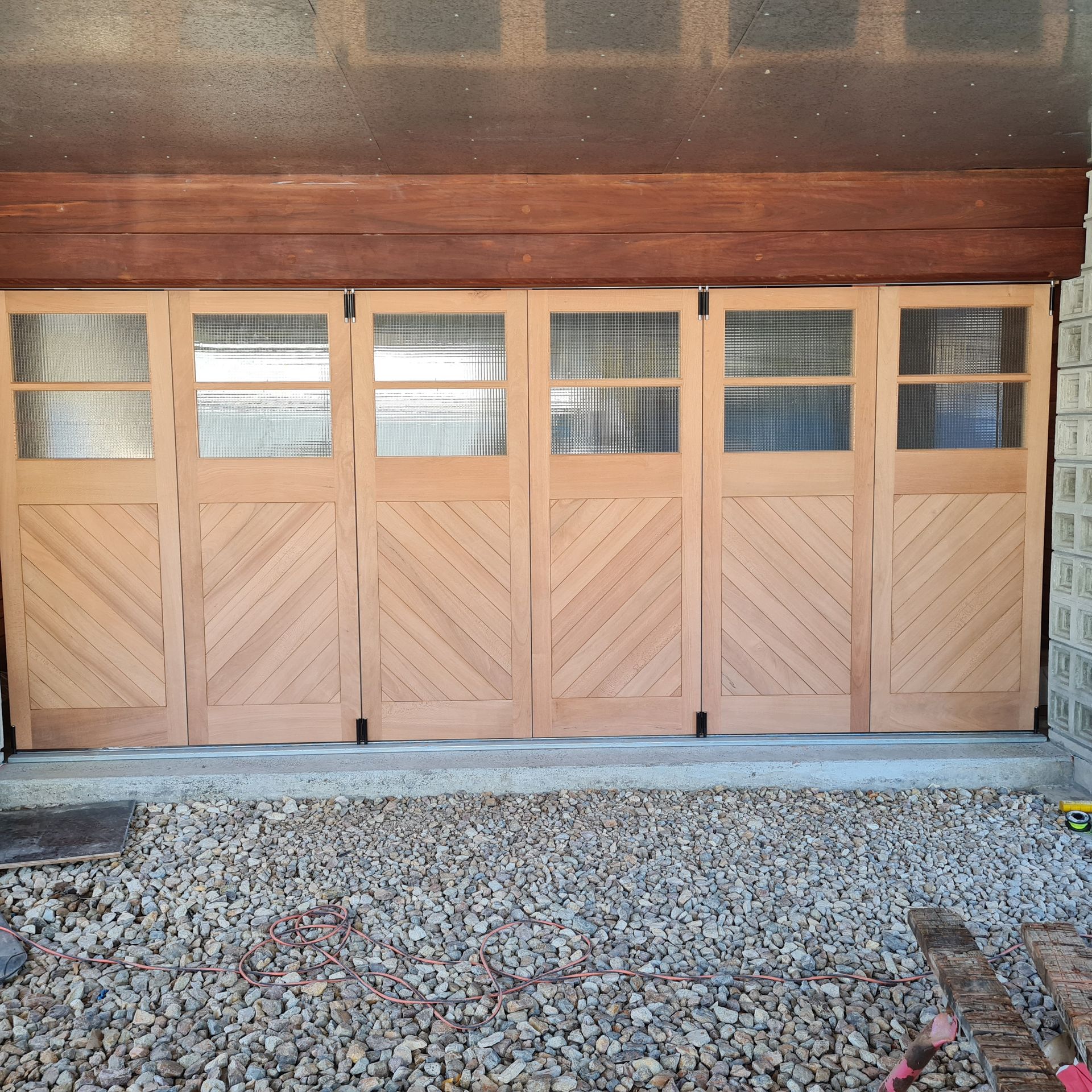 A wooden garage door with a diagonal pattern