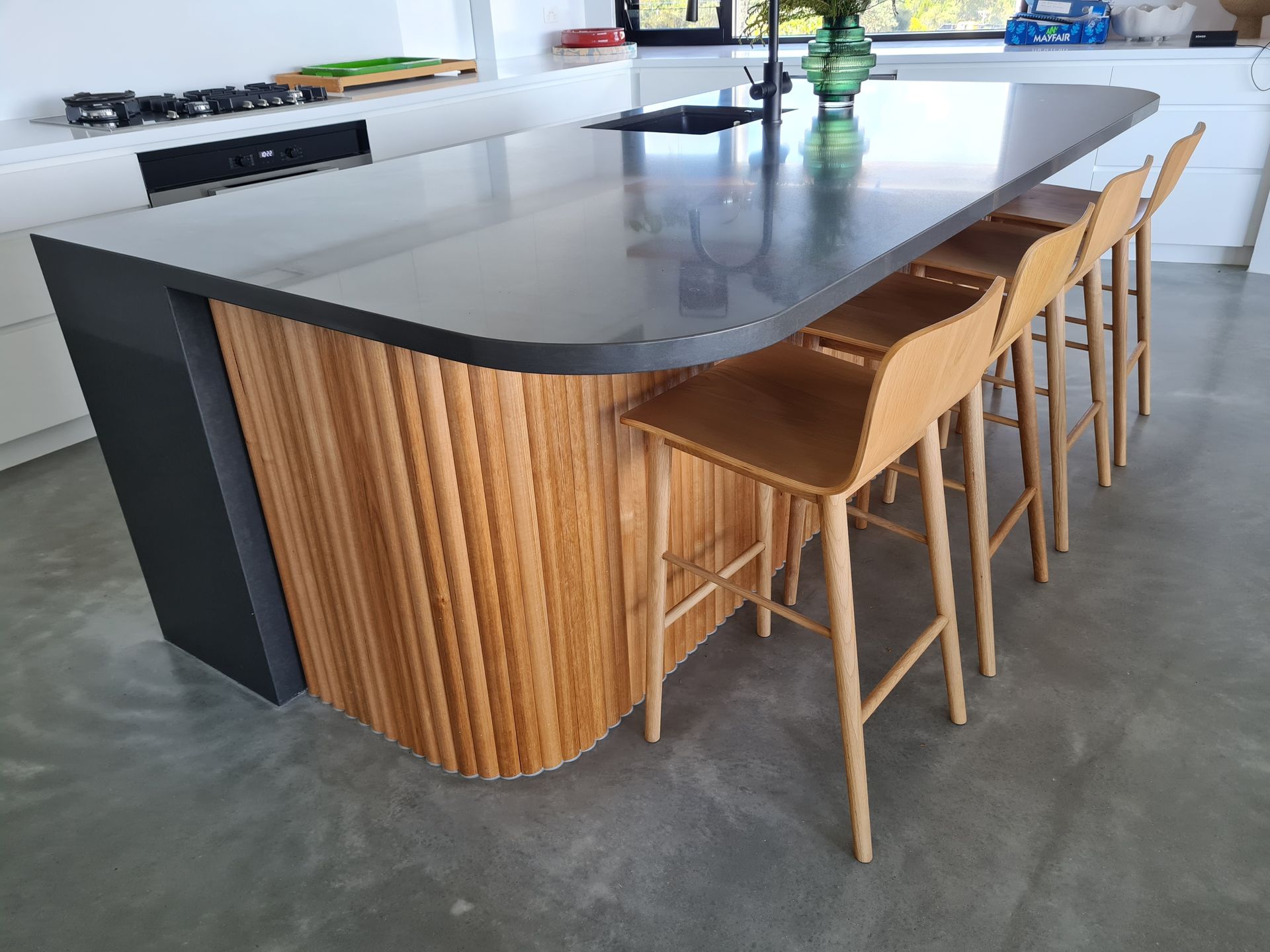 A kitchen with a large island and stools