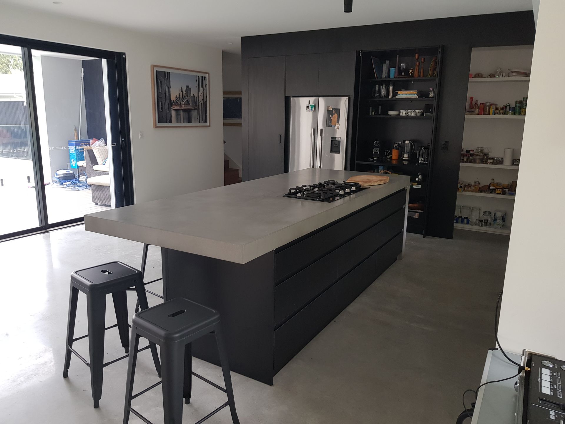A kitchen with a large island and stools
