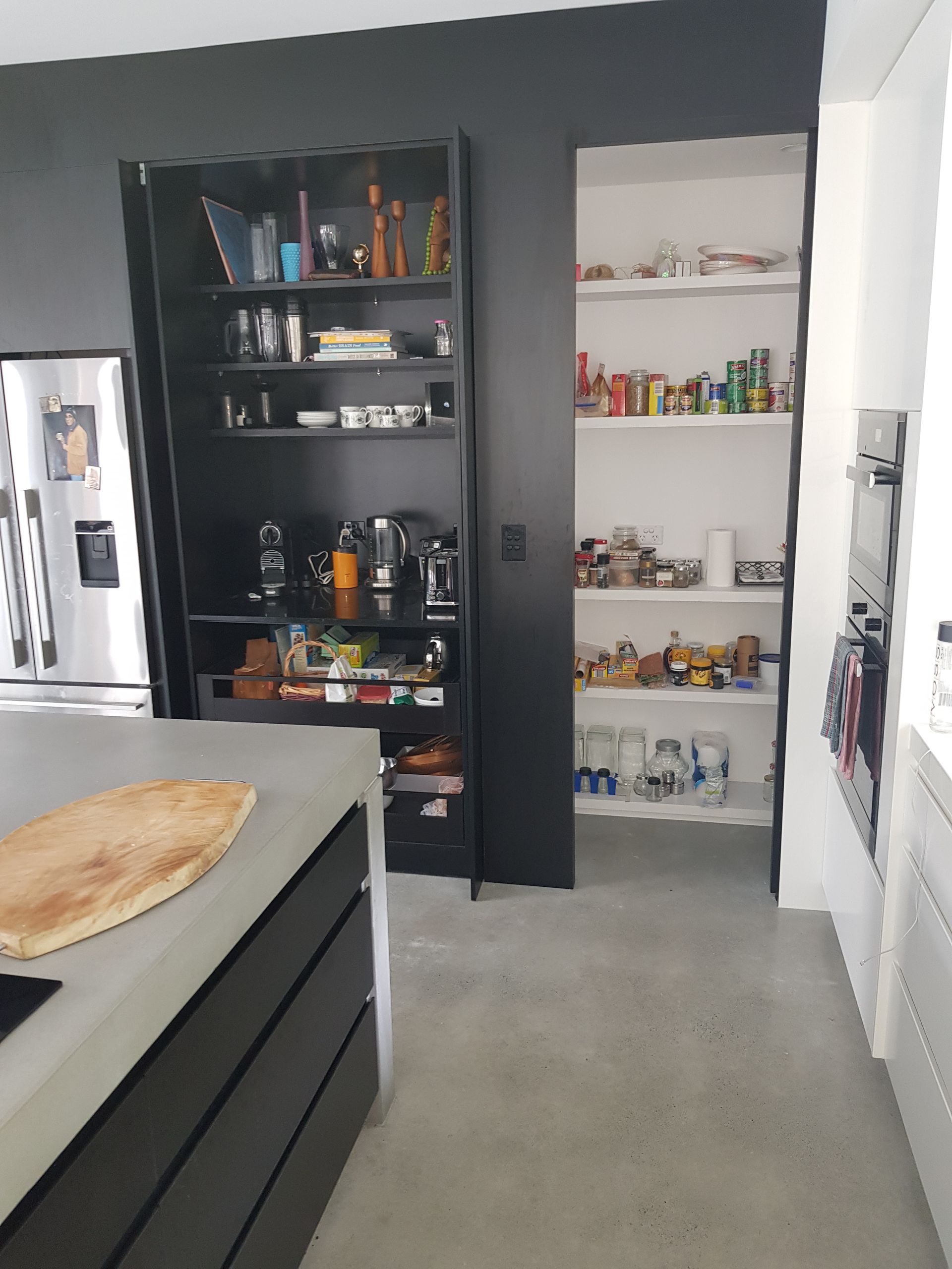 A kitchen with a pantry and a refrigerator