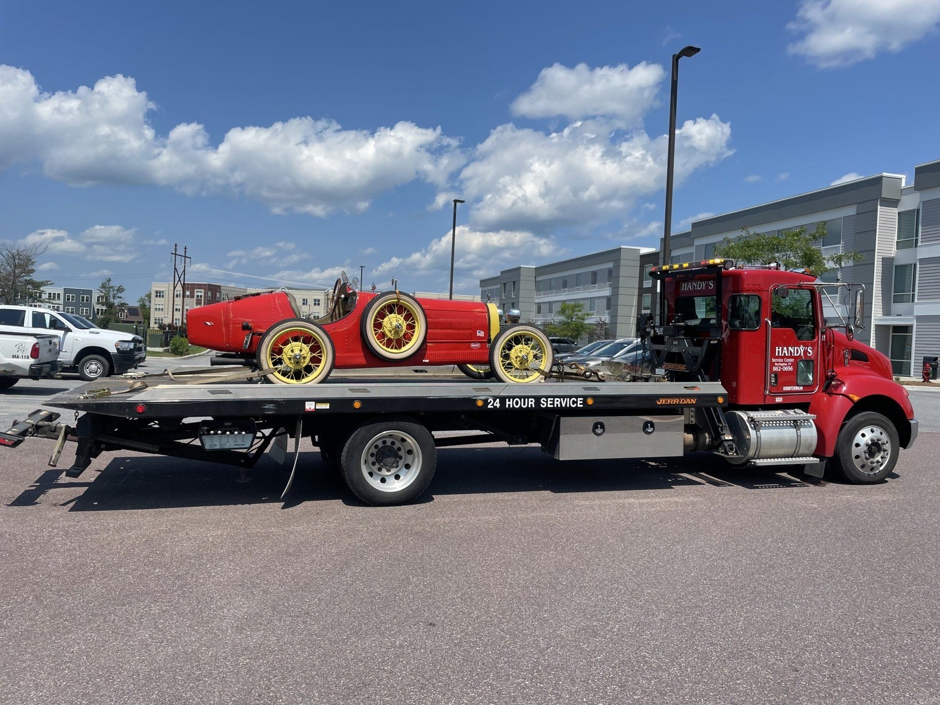 Black Car on a Red Flat Bed Tow Truck - Burlington, VT - Handy's Service Center Black Car on a Red Flat Bed Tow Truck - Burlington, VT - Handy's Service Center