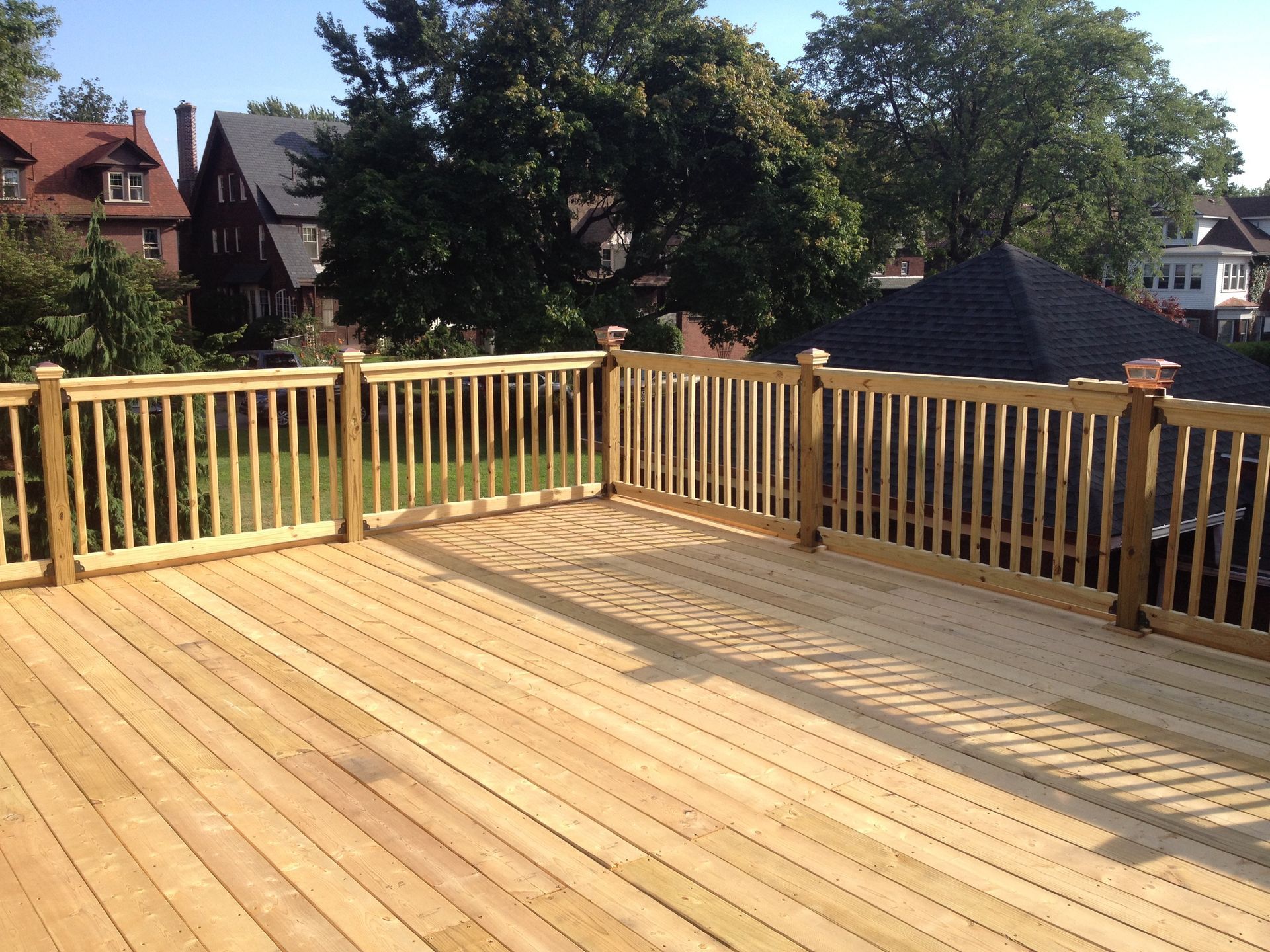 A large wooden deck with a fence around it