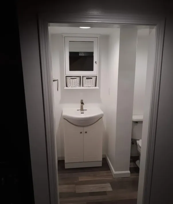 A bathroom with a sink , toilet and mirror.