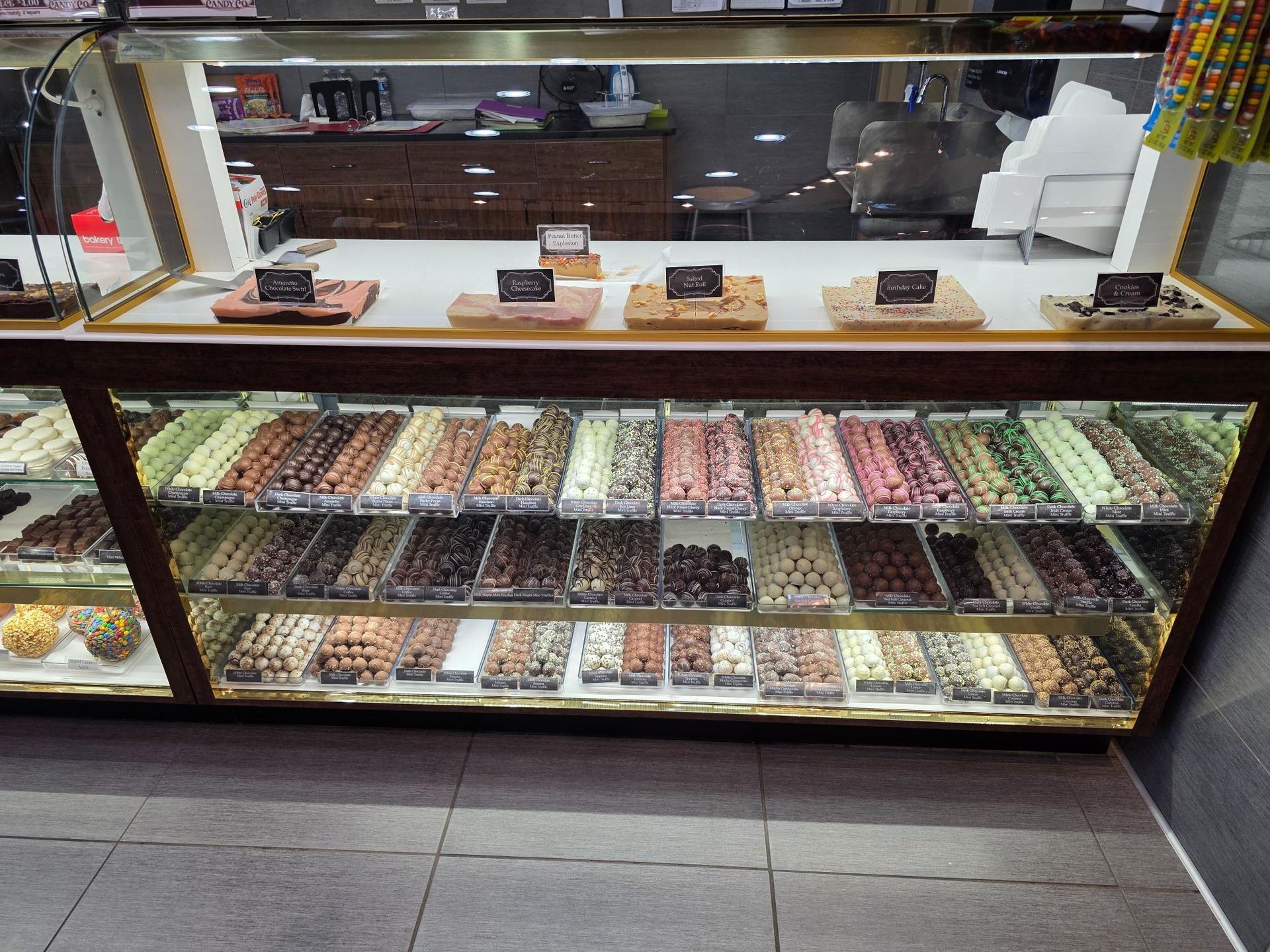 Display case filled with various chocolates and treats, inside a shop.