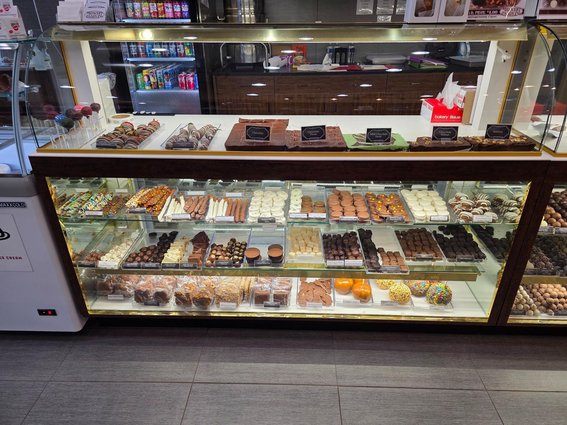 Display case filled with various chocolates and treats, inside a shop.