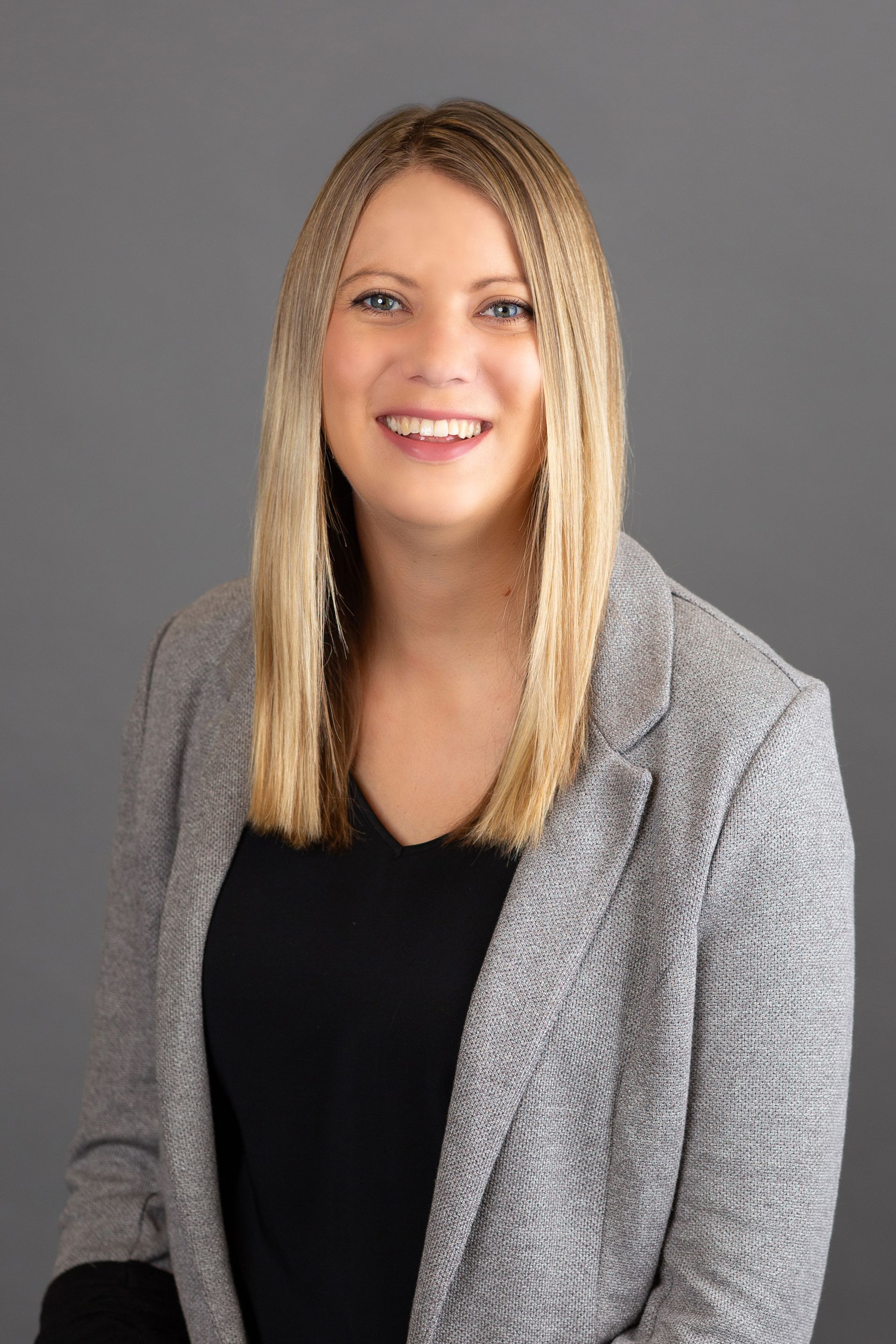 Jenna Johnson, Director of Residential Property Management at Cobalt Properties Group in Bend, Oregon, smiling in office.